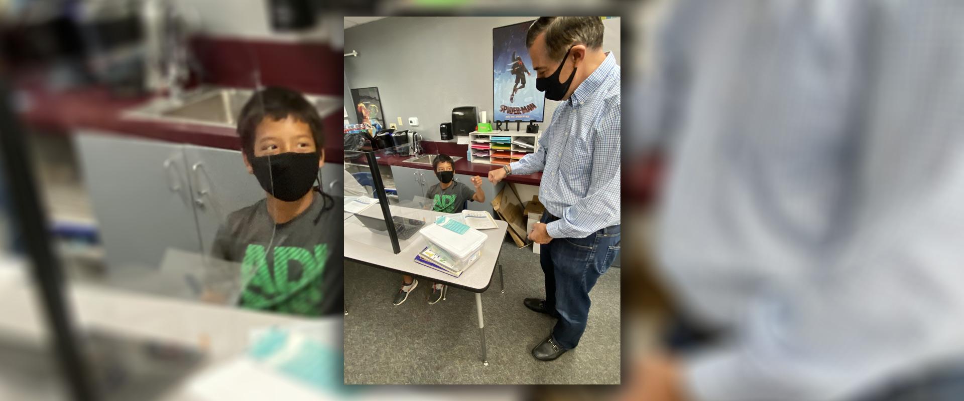 Rep Issa Speaks to and fist bumps a young man.