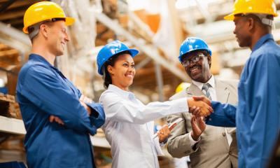 Warehouse manager shaking hands with warehouse worker